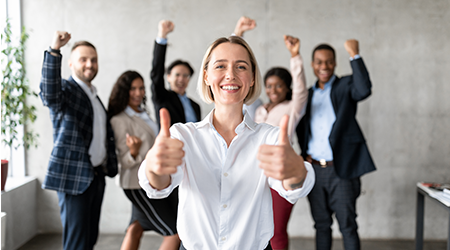 Manager et son équipe levant les pouces en l'air pour signifier leur satisfaction